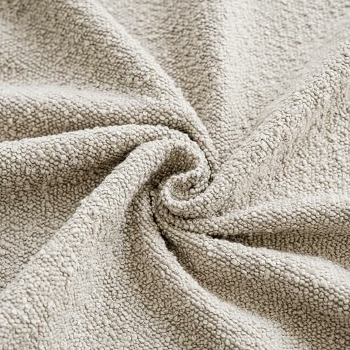 Close-up of beige textured fabric with a swirl pattern