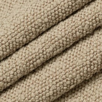 Close-up of beige textured fabric with pebble-like pattern