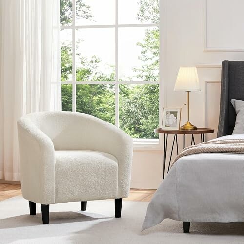 Cozy white chair in a bedroom with natural light.