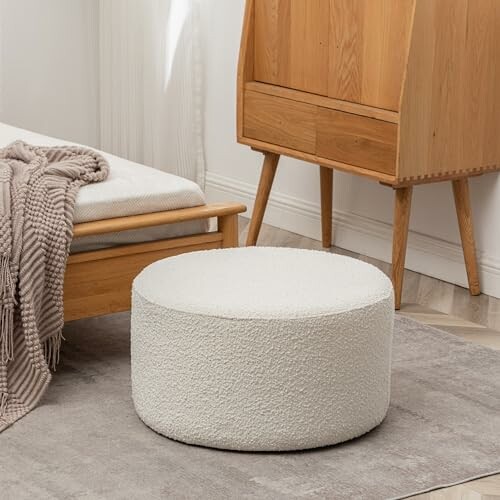 Beige pouf in a cozy bedroom with wooden furniture