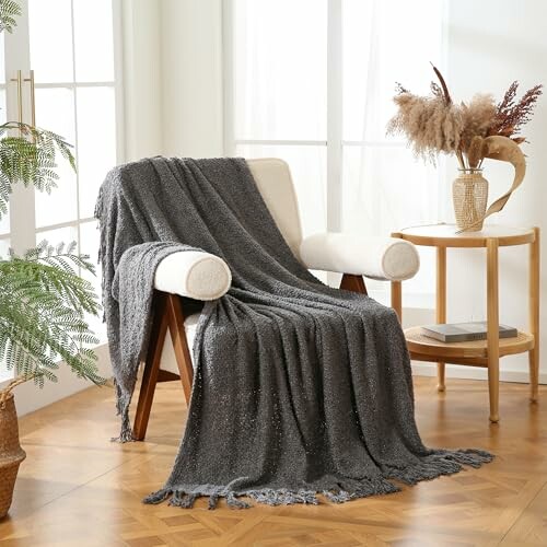 Cozy chair with gray blanket in a sunlit room