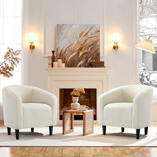 Two white armchairs in a cozy living room with fireplace and artwork.