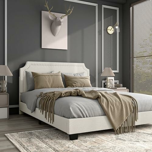 Modern bedroom with gray walls, bed, and decorative elements.