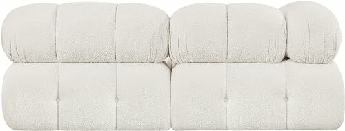 Modern beige upholstered sofa with a tufted design.