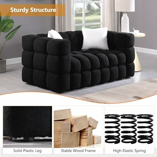 Modern black sofa with sturdy structure and white cushions in a living room.