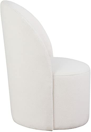 Side view of a modern white accent chair with a curved back.