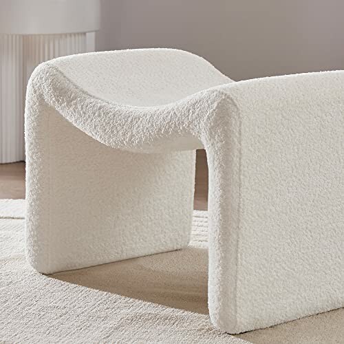 Modern white accent chair with a curved design.