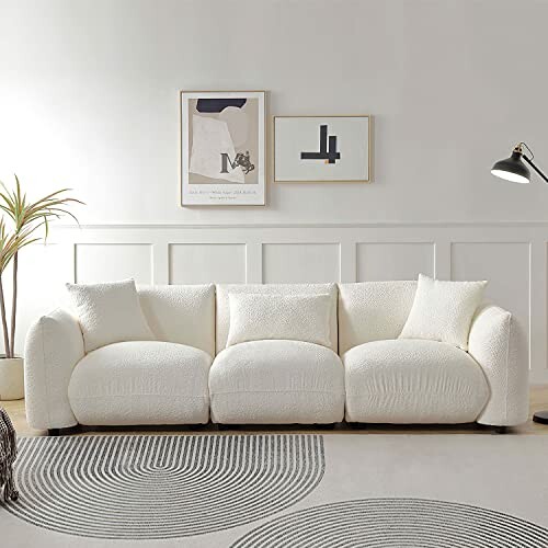 Modern white sofa with cushions in a minimalist living room.