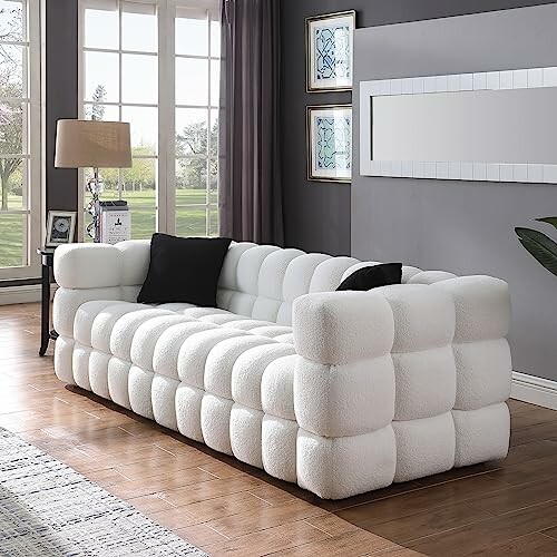 Contemporary white tufted sofa in a stylish living room.