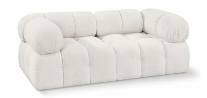 Plush white modern sofa with rounded cushions.