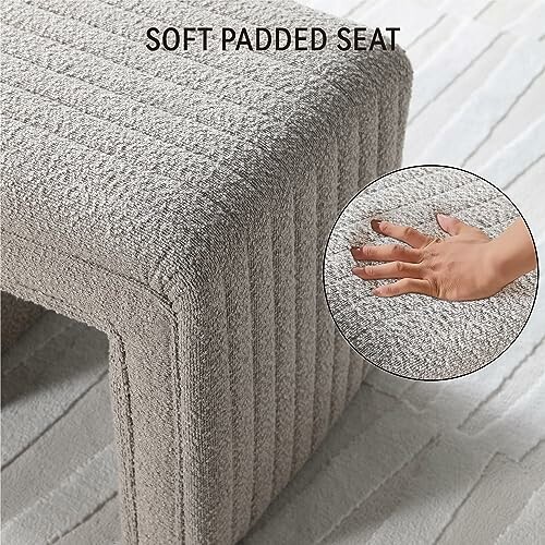 Soft padded seat with a hand pressing on the cushion, showing texture.