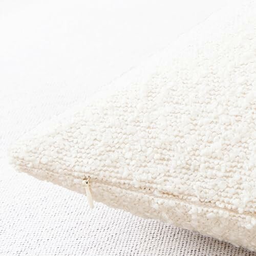 Close-up of a textured white pillow on a light fabric surface