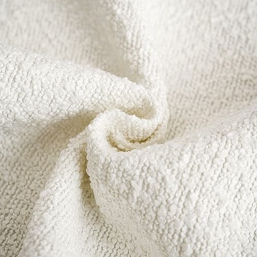 Close-up of white textured fabric with a soft, woven appearance.